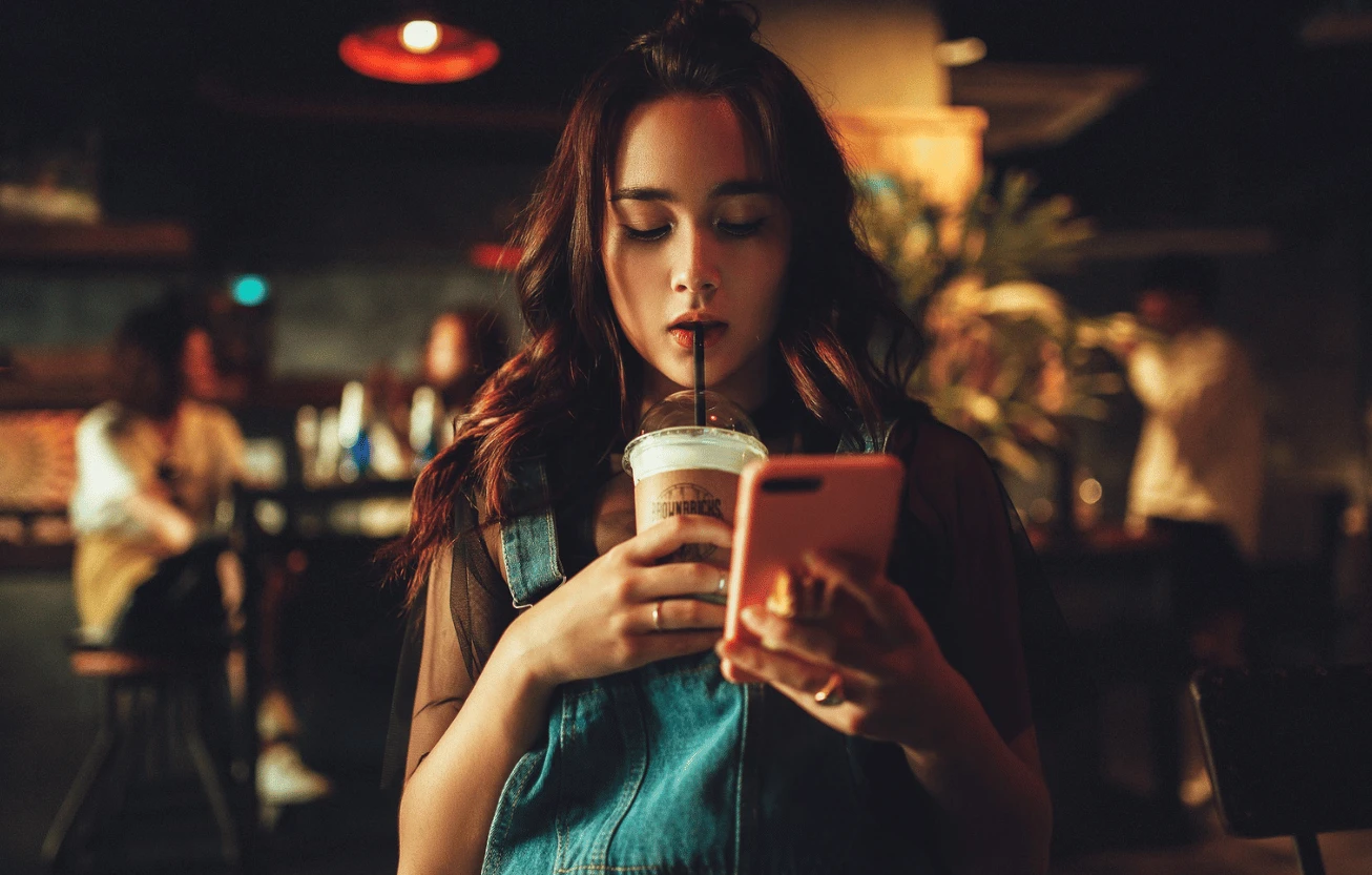 A woman using an app on her phone.