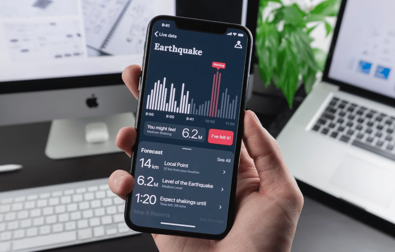 A hand holding a phone showing an app.