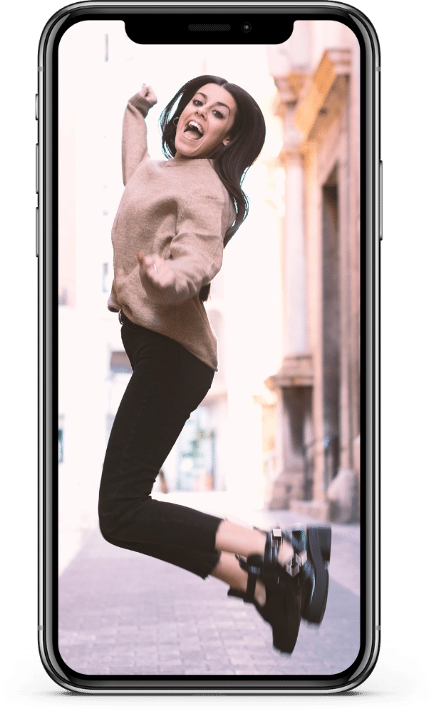 A person celebrating, shown on a phone screen.